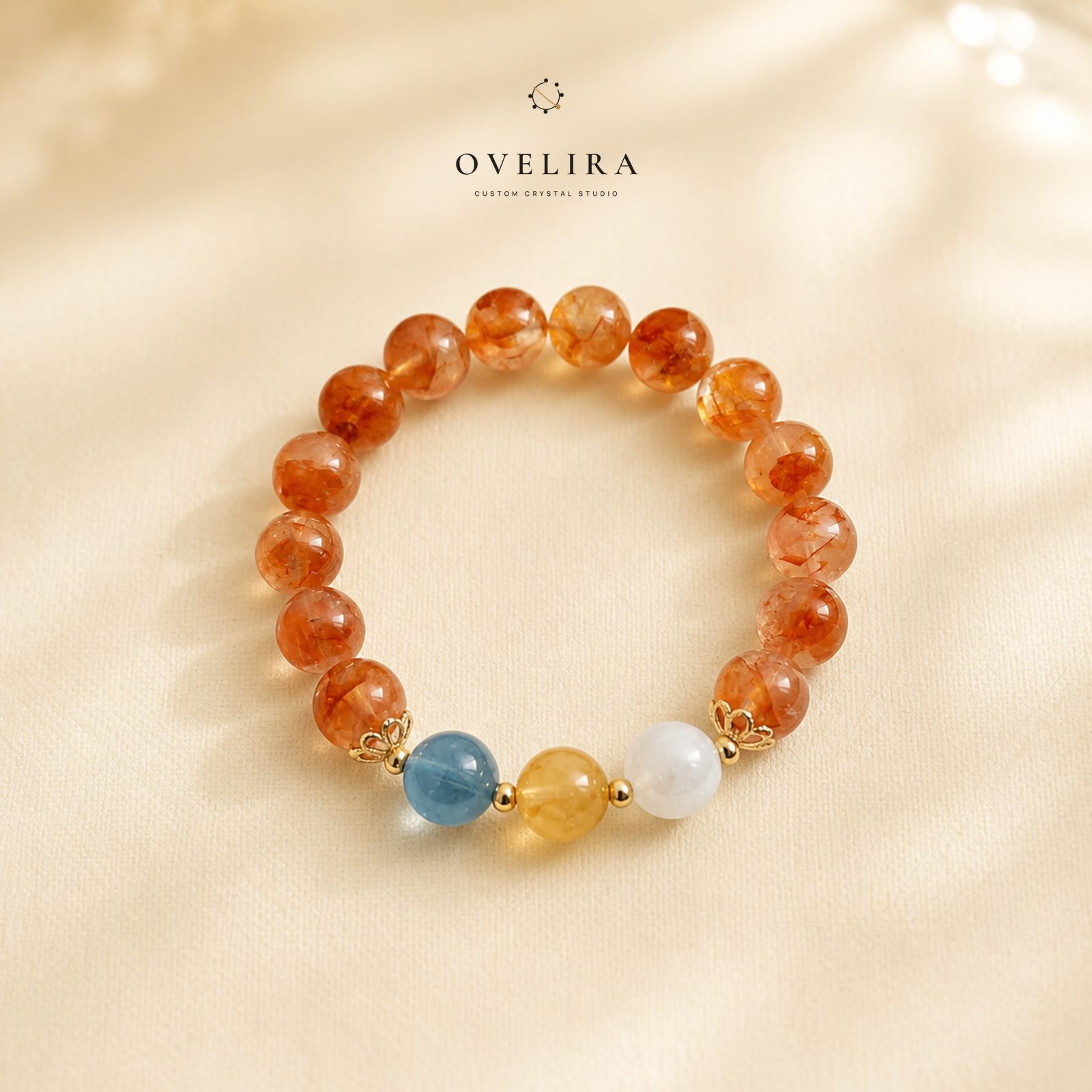 Ember Horizon orange crystal bracelet on a warm ivory OVELIRA background