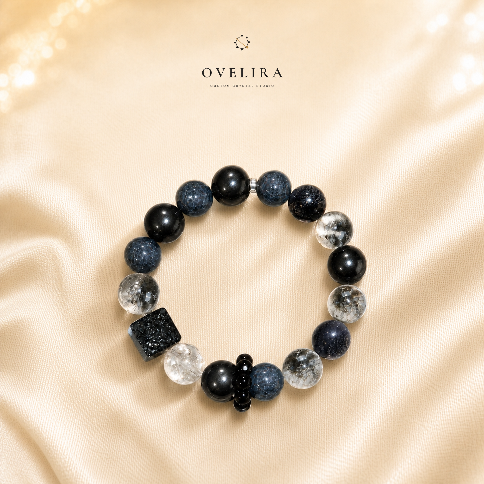 Midnight Constellation black and clear crystal bracelet on a warm ivory OVELIRA background